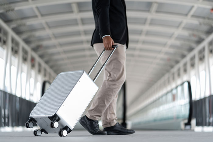 man pulling a suitcase